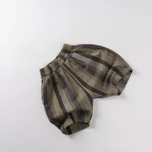 Detail of vintage striped cotton shorts with elastic waistband and olive grey brown tones