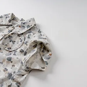 Detail of short-sleeved kid's shirt showing pebble print texture and premium linen fabric