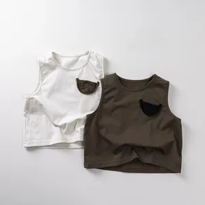 Detail of kids cotton sleeveless vests in cream and olive green with pocket accent