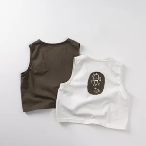 Detail of soft cotton kids sleeveless vest with orange embroidered patch and knit texture