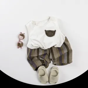 Kids summer cotton set featuring a white sleeveless vest and striped shorts on gray backdrop