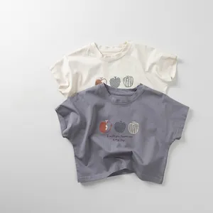 Detailed flat lay of cotton T-shirts with apple prints and happiness message for kids