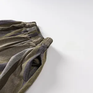 Detail of children's striped shorts featuring elastic waist and side pocket stitching