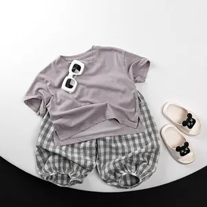 Kids summer two-piece outfit featuring purple t-shirt and grey checkered lantern pants