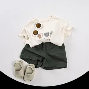 Kids summer outfit set with cream apple print T-shirt and dark green shorts with accessories