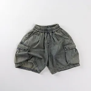 Detail of retro washed denim kids cargo shorts with elastic waist and large side pockets