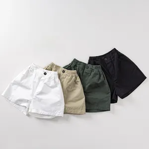 Detailed flat lay of children's cotton shorts in white, khaki, dark green, and black