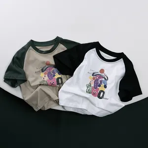 Detail of raglan cotton t-shirts for kids with cartoon prints and sunny day typography