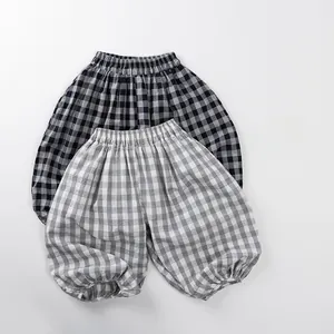 Detailed close-up of breathable plaid mosquito pants with elastic cuffs for kids