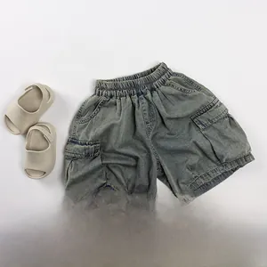 Flat lay of kids denim cargo shorts with elastic waist and side flap pockets