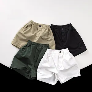 Detailed flat lay of children's cotton shorts in khaki, black, green and white colors