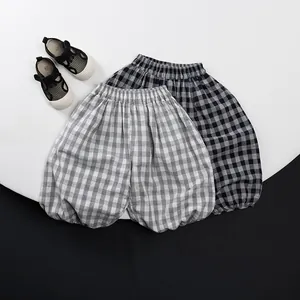 Detailed close-up of breathable cotton plaid harem pants for kids with elastic waist