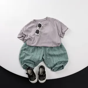 Detailed flat lay of children's short sleeve T-shirt and cotton linen textured trousers