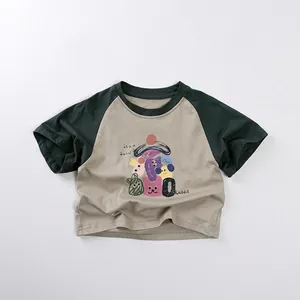 Detail of kids raglan t-shirt featuring cartoon animal print and contrast green sleeves