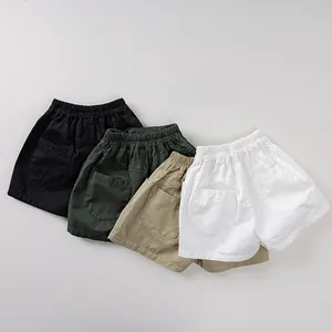 Flat lay of breathable cotton summer shorts for kids in black green khaki and white