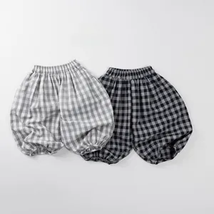 Close-up of children's plaid bloomers showing elastic waistband and cotton fabric texture