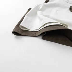 Detail of kids minimalist cotton vest with layered contrast collar in white and brown