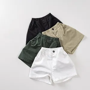 Detail of four colorful kids cotton shorts featuring elastic waist and side pockets