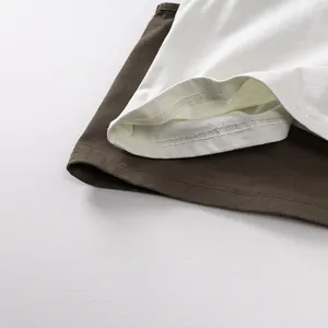 Detailed close-up showing double-needle hem stitching on soft cotton baby vests