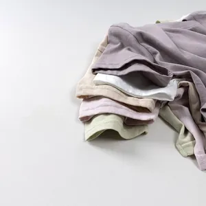 Close-up of vibrant cotton t-shirts showing reinforced necklines and soft fabric texture