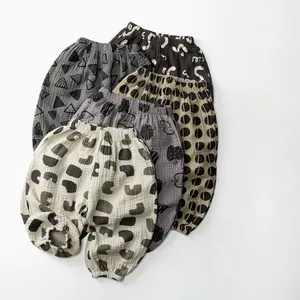 Flat lay of five assorted printed cotton muslin mosquito pants for toddlers in various patterns