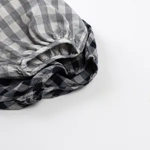 Detailed view of breathable cotton plaid fabric with an elastic waistband for kids' pants