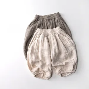 Detailed view of elastic waistband and breathable cotton gauze texture on kids trousers
