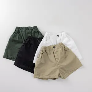 Flat lay of kids cotton shorts in four colors with elastic waist and side pockets