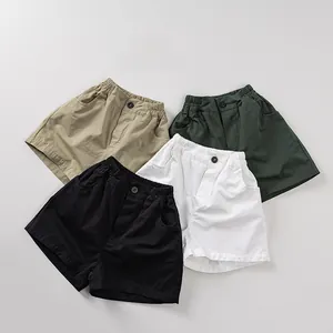 Detail of kids cotton shorts in khaki, green, black and white with elastic waistbands