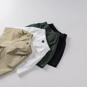 Close-up of kids cotton shorts in khaki, white, green and black with elastic waistband