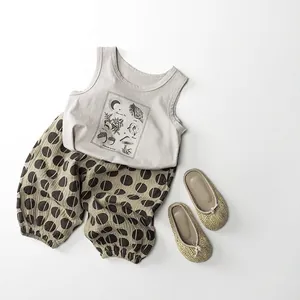 Kids summer two-piece outfit with beige sleeveless tank top and brown polka dot bloomers
