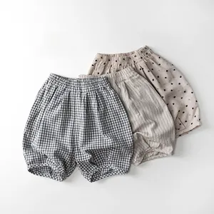 Close-up of children's cotton bloomers in plaid, solid, and polka dot patterns