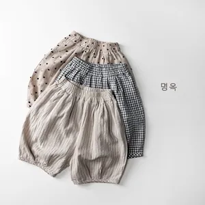 Detail view of cotton linen kids shorts featuring polka dot, plaid, and striped patterns