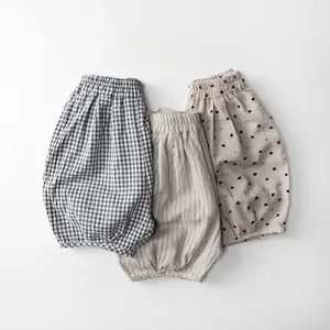 Detailed flat lay of toddler cotton shorts featuring plaid, striped and polka dot patterns