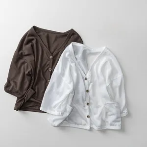 Detailed close-up of V-neck kids' lightweight cardigans with rustic wooden buttons