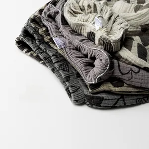 Close-up of soft double-layer cotton gauze kids' pants with elastic waist and cute prints