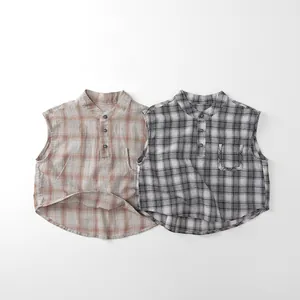 Close-up of kids sleeveless plaid shirts in orange and grey with buttoned collar