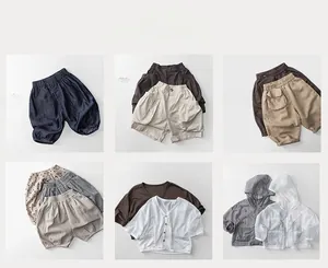 Collection of minimalist kids cotton shorts and summer V-neck T-shirts in neutral tones