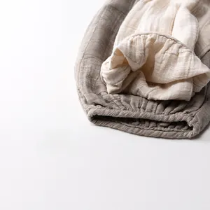 Detailed macro view of breathable cotton gauze baby pants showing elastic ruffled hem