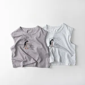 Detailed flat lay of soft cotton toddler vests featuring hand-drawn penguin illustrations