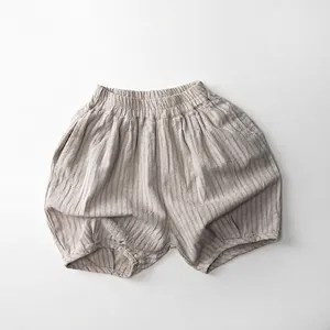 Detail of light brown toddler bloomers with elastic waist and vertical striped cotton linen