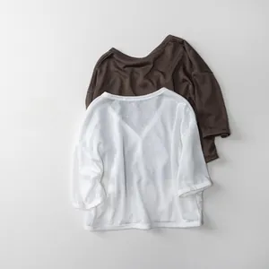 Detail showing white and brown lightweight cotton blend shirts with breathable texture