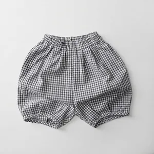 Detail of kids black and white gingham bloomers with elastic waist and soft cotton texture