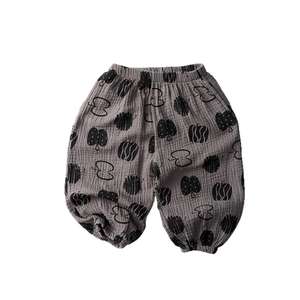 Grey cotton muslin baby joggers with black apple print and elastic ankle cuffs