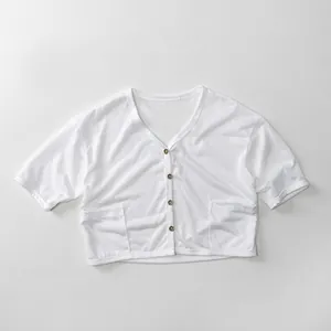 Close-up of white breathable cotton kids cardigan with V-neck and brown buttons