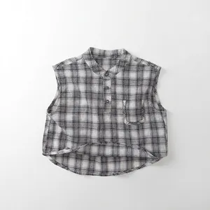 Macro view of checkered kids sleeveless shirt with chest pocket and front buttons