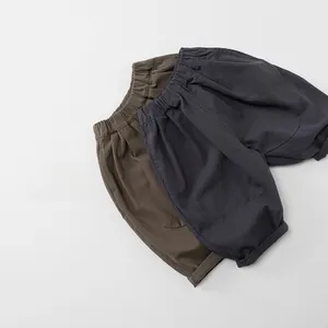 Detailed flat lay of children's cotton wide-leg pants in dark grey and brown colors