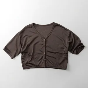 Macro detail of breathable knit fabric and buttons on children brown v-neck cardigan