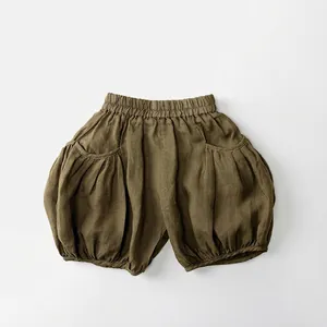 Détail du short citrouille en ramie vert olive montrant la taille élastique et la poche plissée