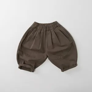 Detail of children's wide-leg cotton pants with elastic high waist and cuffed hems